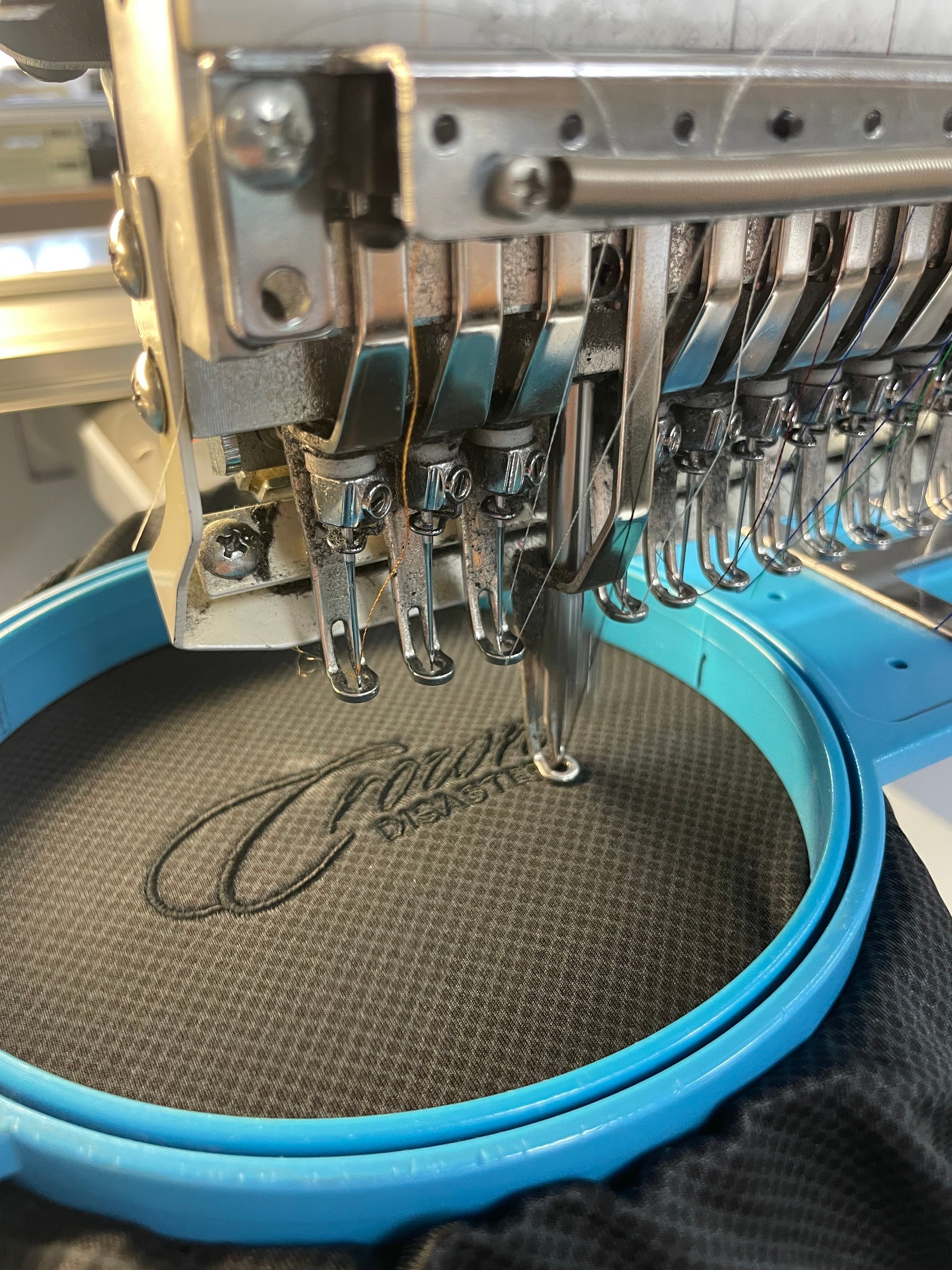 Close-up of embroidery machine stitching a custom logo